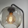 Smoked Glass Globe Shade with Vintage Edison Bulb and Matte Black Metal Wall Lamp - Image 3